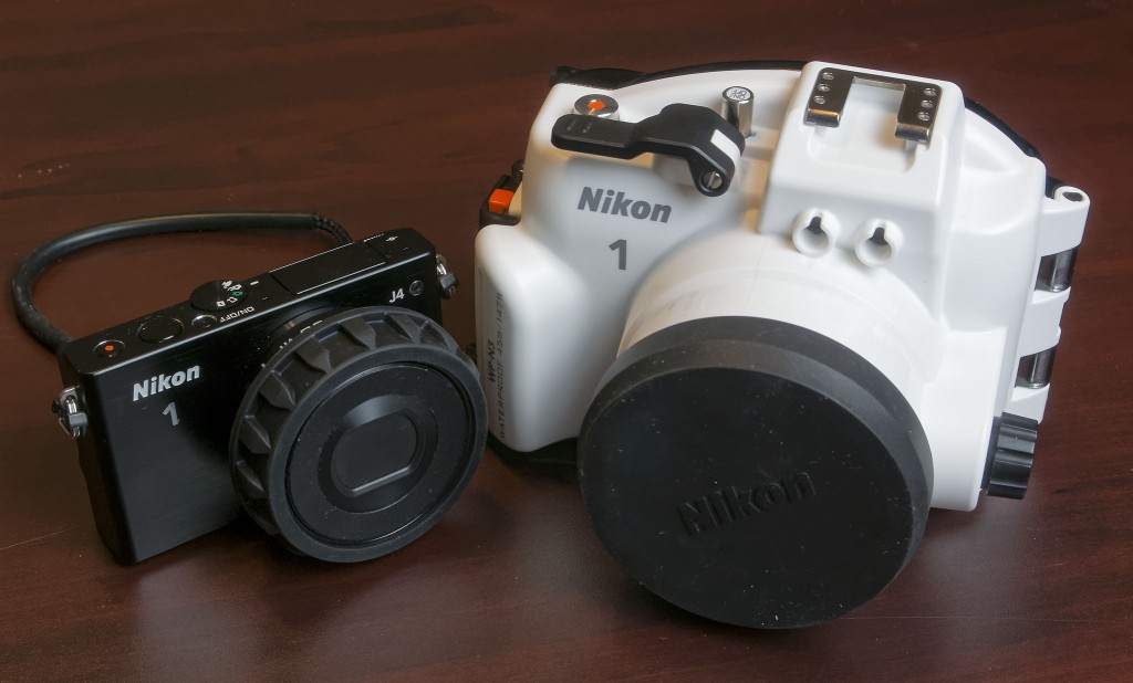 Nikon 1 J4 with 10-30mm f/3.5-5.6 PD zoom. Zoom gear sleeve and inner reflection prevention ring attached to the 10-30mm PD zoom. Nikon 1 WP-N3 waterproof housing for J4/S2.