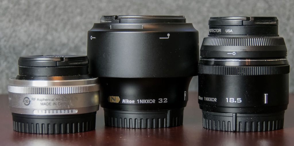 1 Nikon prime lenses. 10mm f/2.8 (left), 32mm f/1.2 (middle), 18.5mm f/1.8 (right)